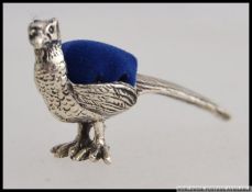 A silver stamped 925 pheasant pin cushio