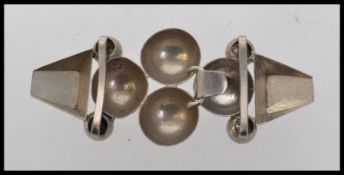 A 1930s Art Deco white metal cloak cape clip clasp with winged lapels. Measures 11cms x 3.