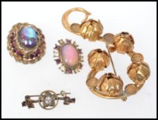A 1940's gold tone brooch stones missing and closed peony flower heads on a scroll form with c