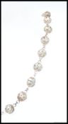 A decorative silver metal ( tests as silver ) fret Bali bead work ball necklace with hook clasp .