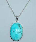 A 925 silver pendant necklace set with a large turquoise cabochon with heavy 925 silver chain.