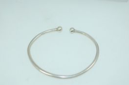 A vintage white metal silver bangle bracelet with ball finials tests silver . Weight 5.