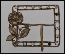 A Georgian white metal buckle set with paste stones with twin looped safety prongs with bow