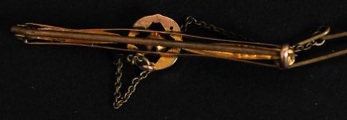 A 9ct gold bar brooch with central circular flower motif complete with safety chain marked 9ct with
