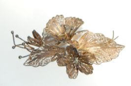 A large vintage white metal tests silver filigree floral spray brooch. Measures 6.5cms.