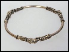 A heavy 925 silver contemporary bangle with Byzantine and frog decoration. Weight 29g.
