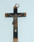 A large Victorian crucifix cross pendent made with ebony mounted on a metal base and bindings.