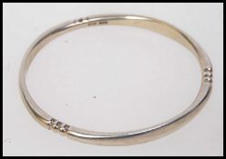 A heavy solid silver contemporary bangle hallmarked for Birmingham. Weight 40g.