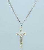 A 925 silver necklace strung with a mother of pearl crucifix cross embellished with a white metal