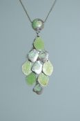 A white metal enamel pendant necklace with drop pendant in the Art Nouveau style.