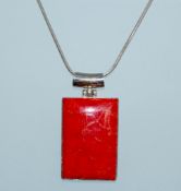 A 925 silver pendant necklace strung with a large red agate stone pendant on a silver snake chain.
