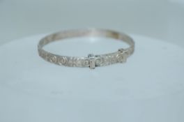 A vintage 925 childs silver bangle bracelet with embossed flower and swirls . Marked S925. Weight 5.