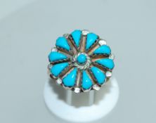 A sterling silver ring with turquoise flower decoration. Size M. Weight 3.