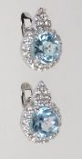 A pair of 925 silver earrings set with an aquamarine style stone and halo CZ in a tear drop shape