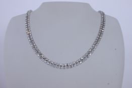 A white metal diamonte choker necklace set with two strings of paste stones . Measures 16 inches.