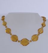 A 1930s Art Deco Czech glass bead necklace with faceted amber and seed cut clear glass beads with
