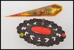 A vintage amber bakelite brooch with floral decoration and pin clasp. Measures 10cms.