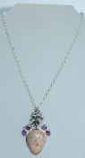 A 925 silver pendant necklace set with a large millifiori cabochon in a floral and paste 925 silver