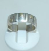 A 925 silver band ring with geometric gold decoration. Size O. Weight 3.