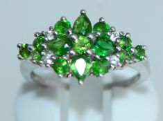 A 925 silver ring with cathedral set green peridot gem stones. Size N.5. Weight 2.