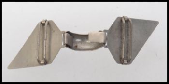 A 1930s art deco white metal cloak cape clip clasp with winged lapels. Measures 11cms x 3.