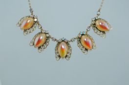 A vintage circ 1950s gold tone necklace hung with filigree cicada with simulated pearl bodies with