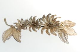 A large vintage white metal tests silver filigree floral spray brooch. Measures 8.5cms.
