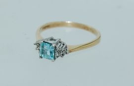 A 9ct hallmarked Art Deco style gold ring set with a central square cut aquamarine with diamond