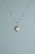 A 925 silver pendant necklace strung with a heart shape locked with foliate engraving on a silver