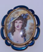 A 1950s Thomas L Mott yellow metal brooch with over painted portrait with enamel decorated frame
