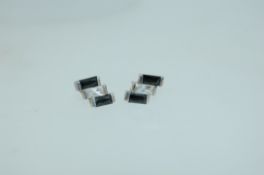 A pair of 925 silver earrings set with CZ and dark blue gem stones in geometric setting with push