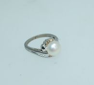 A 925 silver ring with central pearl surrounded by a clear stone halo. Size L. Weight 2.