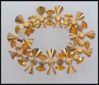 A vintage designer vintage stylised gold tone bracelet with purple faceted stones and a invisible