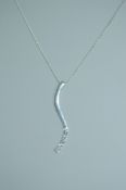 A 925 silver pendant necklace strung with an clear stone set stylized drop pendant on a fine silver
