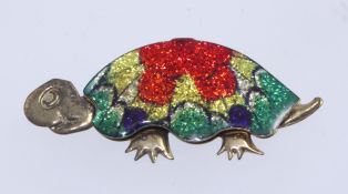 A vintage yellow metal foil back brooch in the form of a tortoise with square c clasp Measures 5cms.
