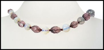 A 1930s long glass Czech bead necklace strung with faceted Amethyst,