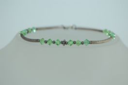 A 925 silver bangle bracelet with silver and crystal beads and round claw clasp. Marked 925.