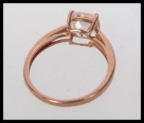 A hallmarked 9ct gold dress ring with square cut Morganite gem stone in a prong setting. Size N.