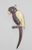 A 1950s yellow metal and enamel parrot brooch with fixed safety pin style clasp . Measures 6cms.