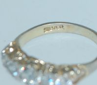 A vintage silver ring with 5 CZ in a gypsy setting marked silver. Size J. Weight 2.