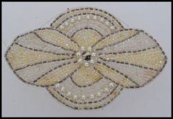 Two 1920s large beadwork motifs in the shape of a orchid flower. Measures 11cms.