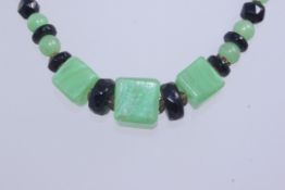 A 1930s Art Deco glass bead necklace with green square cut,