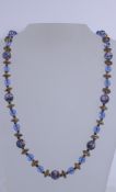 A 1950s Venetian wedding cake blue glass bead necklace with graduated round painted beads