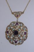 A vintage circ 1950s gold tone statement necklace hung with a large rococo pendent set with