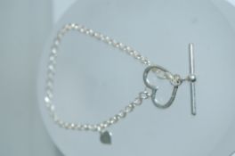 A 925 silver belcher link bracelet with heart charm and heart toggle clasp. Measures 7.5 inches.