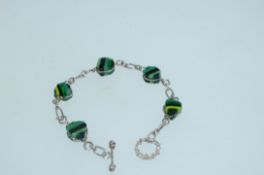 A 925 silver Italian end of day glass bracelet with twisted silver setting and toggle clasp.