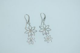A pair of 925 silver earrings with pierced flower shaped drops and fishhook backs. Weight 2.4g.