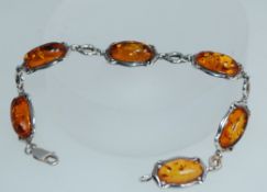 A 925 silver bracelet set with amber cabouchons in Art Nouveau style silver links with lobster claw
