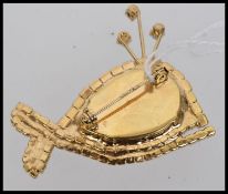 A large vintage whale brooch set with a central faceted stone with pave set body and delicate blue