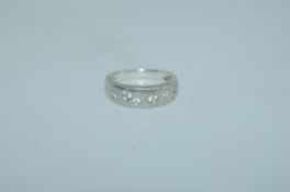 A contemporary 925 silver band ring with bezel set CZ within a plain band. Size Q. Weight 5.1g.